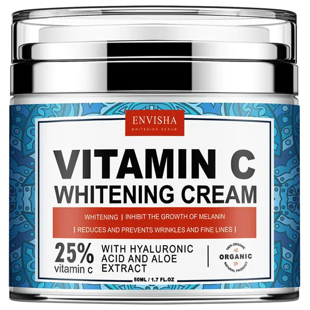 Blå burk med silvrigt lock. Beskrivning att krämen ljusar upp hyn samt att det är 25% vitamin C i burken. Engelsk text.